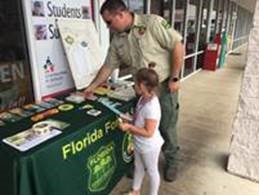 Little girl reading brochure.